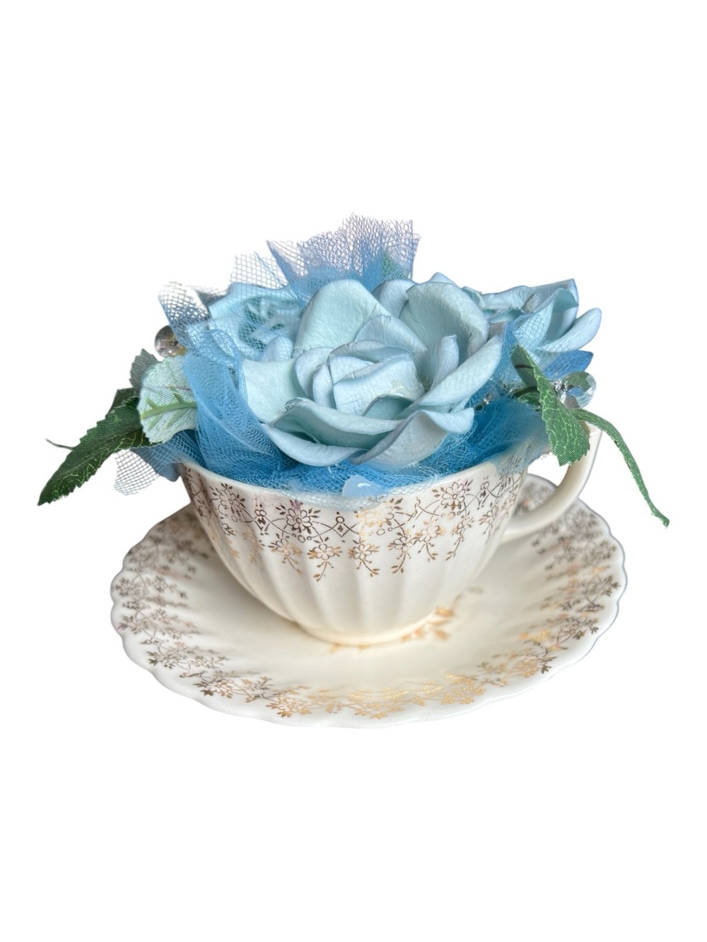 American Limoges vintage Teacup and saucer with blue artificial flowers.